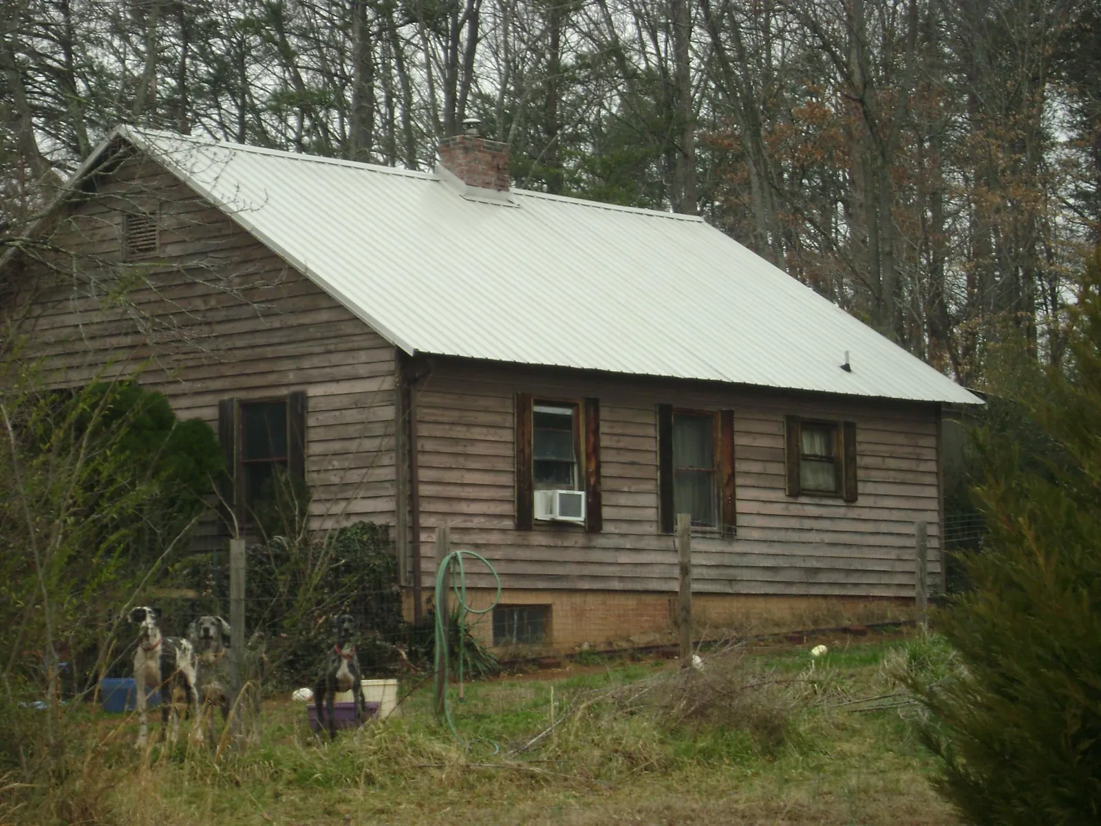 White metal roof on an old wood sided farmhouse, from a Metal Roof Installation job in Winsted